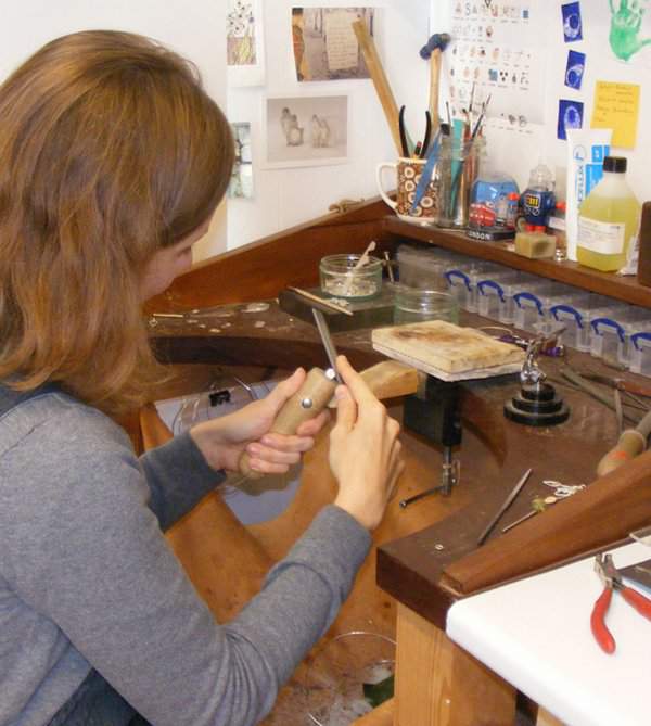Emma filing at her work bench