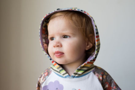 Rainy days rainbow dress. A mashup of the Safari Raglan dress with the Rowan Tee hood, both patterns by Titchy Threads.