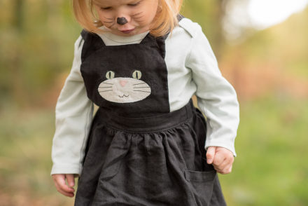 Black cat pinafore bib close up